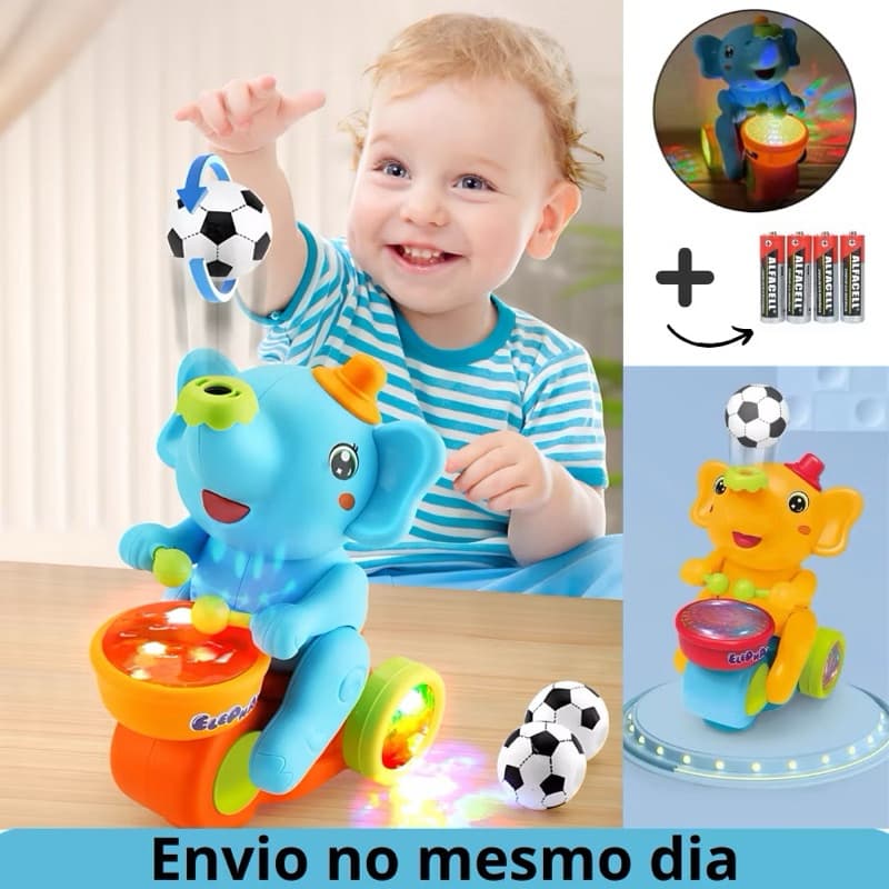 Brinquedo Infantil Colorido Elefante Baterista Que Anda Com Rodinhas E Assopra Uma Bola Para O Alto